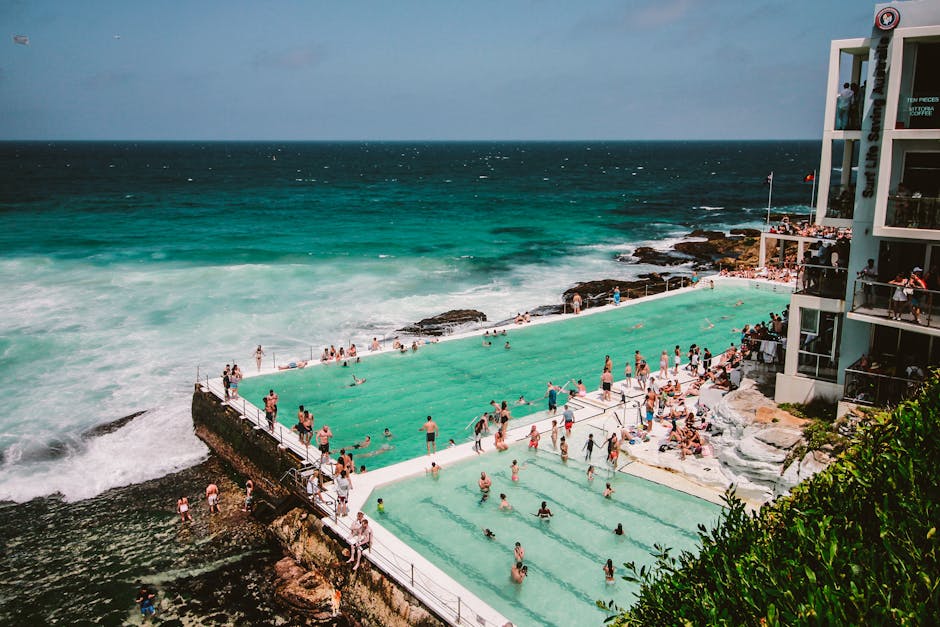 A vibrant scene of people enjoying the Bondi Icebergs swimming pool by the ocean in Sydney, Australia